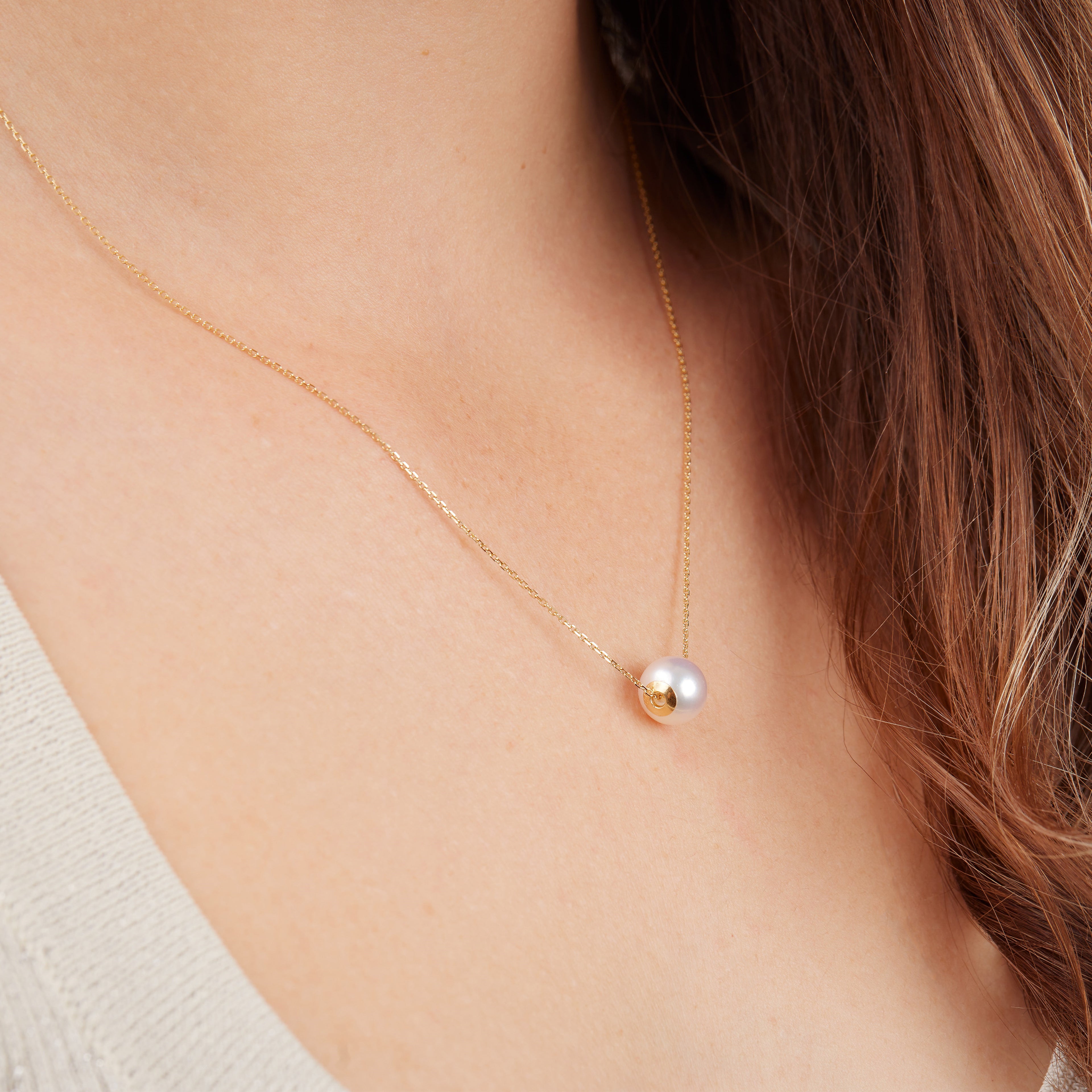 18k gold akoya ocean pearl necklace on a woman